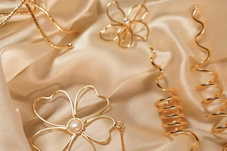 ANIKI kids jewellery pieces arranged on soft satin fabric
