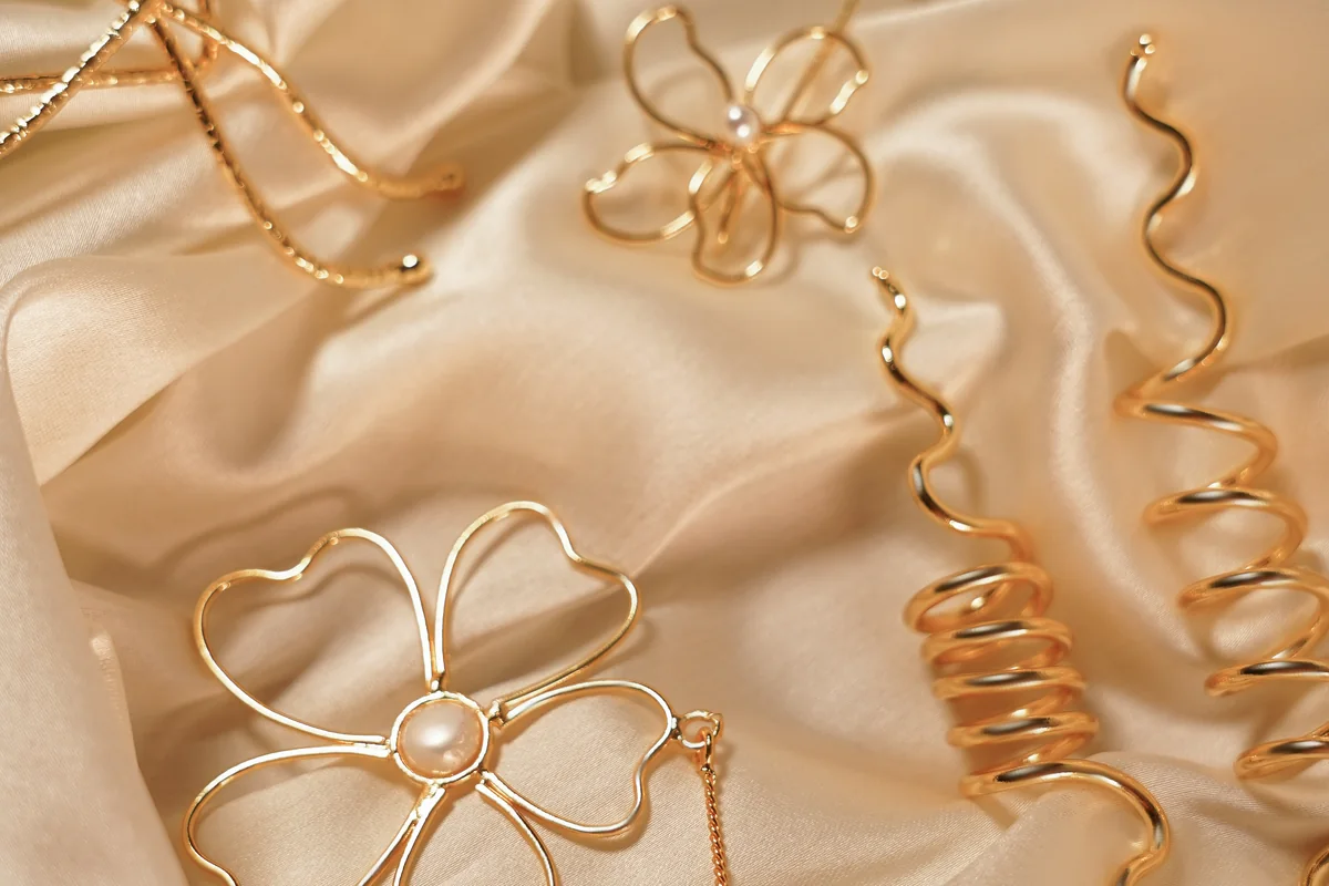 ANIKI kids jewellery pieces arranged on soft satin fabric