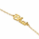 Gold-tone rakhi bracelet for brother featuring a Bhaiya charm pendant