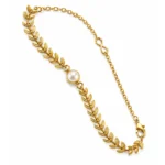 Kids pearl necklace with tiny pearls and gold-tone leaf pendant, close-up on white background
