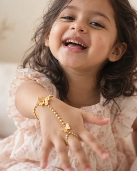 Laughing little girl reaching out, wearing the ANIKI Butterfly Hand Harness